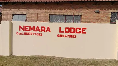 a sign for ancaza lodge in front of a building at NEMARA Self Catering Lodge in Polokwane
