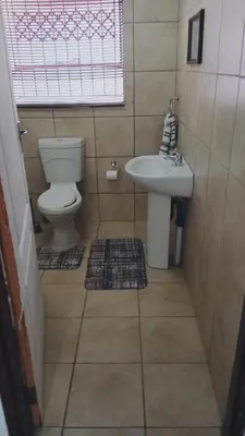 a bathroom with a toilet and a sink at NEMARA Self Catering Lodge in Polokwane