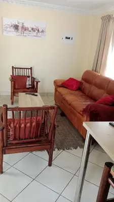 a living room with a couch and two chairs at NEMARA Self Catering Lodge in Polokwane