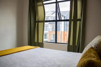 a bedroom with a bed and a window at 5 The Blyde Crystal Clear 2 Bedroom Apartment in Pretoria