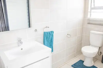 a bathroom with a toilet and a sink at 507 The Blyde Crystal Clear Lagoon 2 Bedroom Apartment in Pretoria