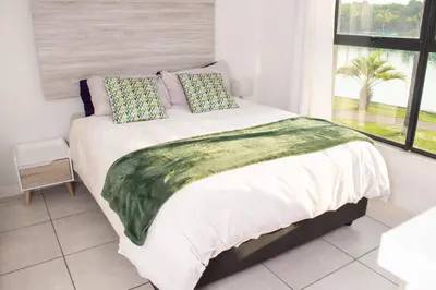 a bedroom with a large bed with a window at 1523 The Blyde Crystal Clear 2 Bedroom Apartment in Pretoria