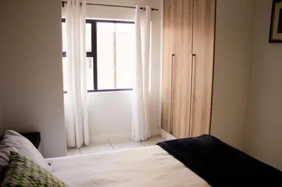 a bedroom with a bed and a large window at 1523 The Blyde Crystal Clear 2 Bedroom Apartment in Pretoria