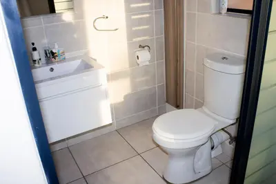 a bathroom with a white toilet and a sink at 1523 The Blyde Crystal Clear 2 Bedroom Apartment in Pretoria