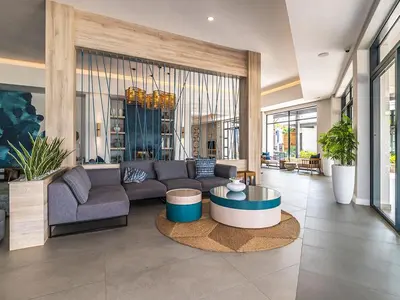 a living room with a couch and a table at 11 The Blyde Crystal Clear Lagoon 2 Bedroom Garden Apartment in Pretoria