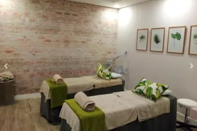 a hospital room with two beds and a brick wall at 11 The Blyde Crystal Clear Lagoon 2 Bedroom Garden Apartment in Pretoria