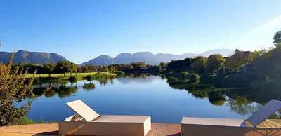 a view of a river with mountains in the background at The Pecan Lake Guesthouse in Hartbeespoort
