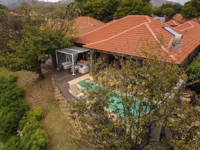 an overhead view of a house with a swimming pool at The Pecan Lake Guesthouse in Hartbeespoort