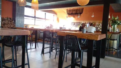 a bar with wooden bar stools in a restaurant at 1253 The Blyde Crystal Clear 3 Bedroom Garden Apartment in Pretoria