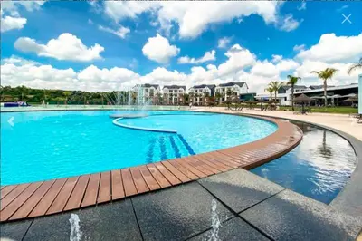 a large swimming pool with a water fountain at 1253 The Blyde Crystal Clear 3 Bedroom Garden Apartment in Pretoria