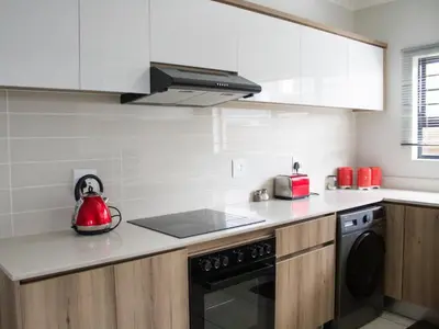 a kitchen with a stove and a red appliance at 1253 The Blyde Crystal Clear 3 Bedroom Garden Apartment in Pretoria