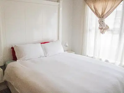a white bed in a bedroom with a window at 1254 The Blyde Crystal Clear 3 Bedroom Garden Apartment in Pretoria