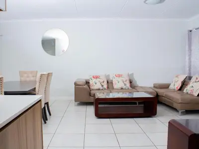 a living room with a couch and a table at 1254 The Blyde Crystal Clear 3 Bedroom Garden Apartment in Pretoria