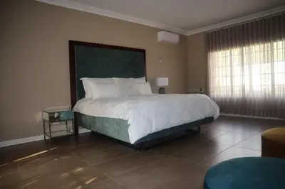 a bedroom with a large bed in a room at The Meander Estate in Balmoral