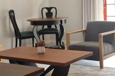 a table and chairs in a living room with a table and a chair at The Meander Estate in Balmoral