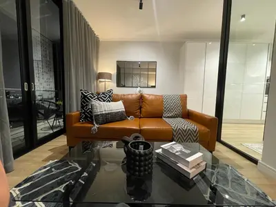 a living room with a couch and a glass table at Exec Oasis @Ellipse in Midrand