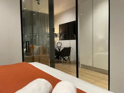 a bedroom with a bed and a living room at Exec Oasis @Ellipse in Midrand