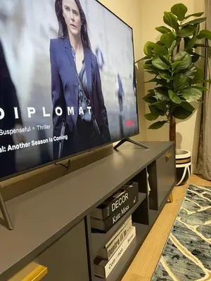 a flat screen tv sitting on top of a table at Exec Oasis @Ellipse in Midrand