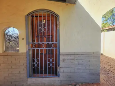 an iron gate on the side of a building at Kuntuala House in Pretoria