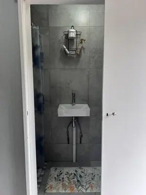 a bathroom with a sink and a shower at Kuntuala House in Pretoria