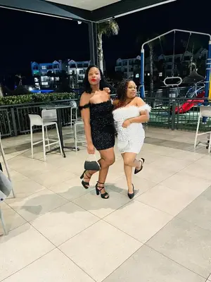 two women are standing next to each other at THE BLYDE Holiday Apartments in Pretoria