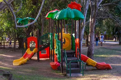a playground in a park with colorful playground equipment at Kruger Park Lodge Unit No. 209 in Hazyview