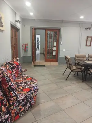 a living room with a couch and a table at Africa Dawn Guesthouse in Musina