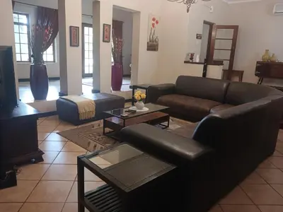 a living room with a couch and a table at Africa Dawn Guesthouse in Musina