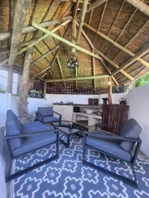 a living room with blue chairs and a table at ScenicViews@103 in Hartbeespoort