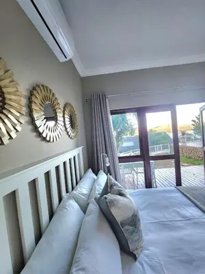 a bedroom with a bed and a mirror on the wall at ScenicViews@103 in Hartbeespoort