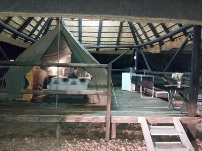 a tent with a stove inside of it at Unathi Game Lodge in Tshwee