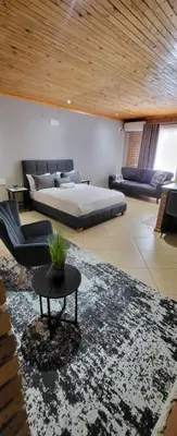 a large living room with a bed and a couch at 801 Guesthouse in Springs