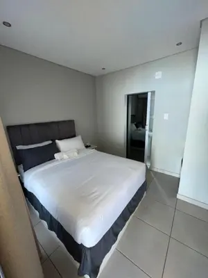 a bedroom with a large white bed in a room at 801 Guesthouse in Springs