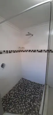 a shower with a glass door in a bathroom at Cozy Guest in Graskop