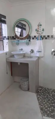 a bathroom with a sink and a mirror at Cozy Guest in Graskop