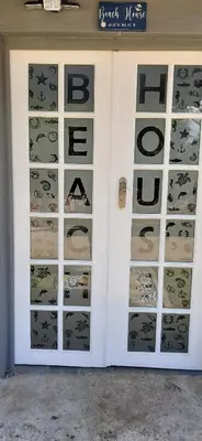 a door to a store with the words bcci at Cozy Guest in Graskop