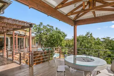 a patio with a table and chairs on a deck at Elements Private Golf Reserve House 197 in Bela-Bela