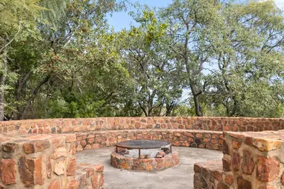 a brick wall with a table in front of it at Elements Private Golf Reserve House 197 in Bela-Bela