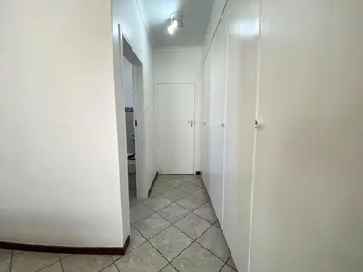 a hallway with white doors and a tile floor at Siena Sun Apartment 4 in Midrand