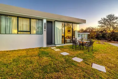 a house with a table and chairs in the yard at KRAVIT Premier Suites in Midrand