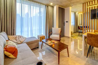 a living room with a couch and a table at KRAVIT Premier Suites in Midrand