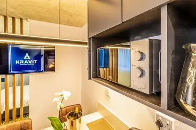 a kitchen with a restaurant sign on the wall at KRAVIT Premier Suites in Midrand