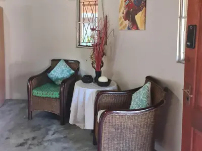 two chairs and a table in a room at Thandolwami Bushlodge in Hoedspruit
