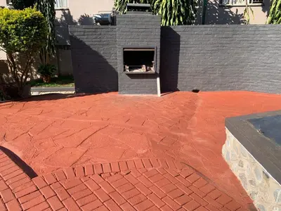 a brick patio with a fire place in a backyard at Victoria guest house Nyumbani in Tzaneen