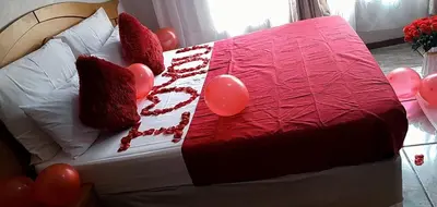 a bed with balloons on it with a red blanket at Victoria guest house Nyumbani in Tzaneen
