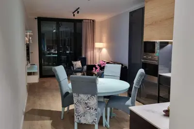 a dining room and living room with a table and chairs at Ellipse Waterfall - The Loft at Cassini in Midrand