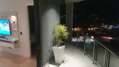 a balcony with a potted plant on the side of a building at Ellipse Waterfall - The Loft at Cassini in Midrand
