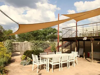 a patio with a table and chairs and a deck at 46 Welgevonden in Dinokeng in Dinokeng Game Reserve