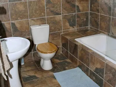 a bathroom with a toilet and a tub and a sink at 46 Welgevonden in Dinokeng in Dinokeng Game Reserve