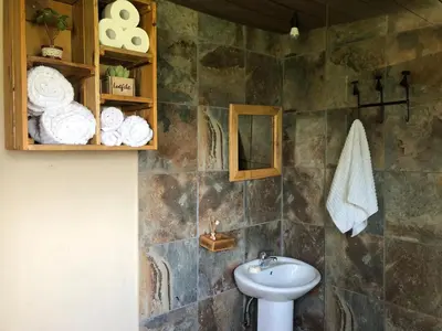 a bathroom with a sink and a toilet and towels at 46 Welgevonden in Dinokeng in Dinokeng Game Reserve